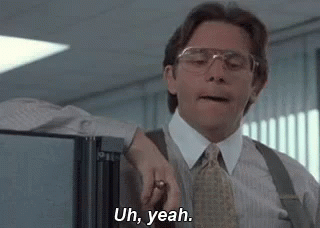 A Man In A Suit And Tie Is Standing In Front Of A Refrigerator And Saying Uh , Yeah . GIF