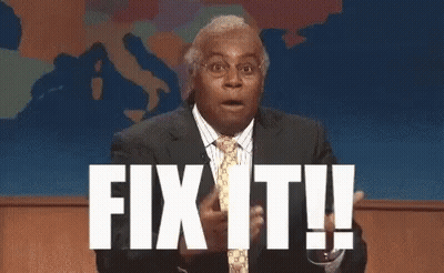 A Man In A Suit And Tie Is Standing In Front Of A Screen That Says Fix It ! GIF