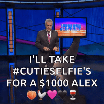 A Man In A Suit And Tie Is Standing In Front Of A Screen That Says Jeopardy GIF