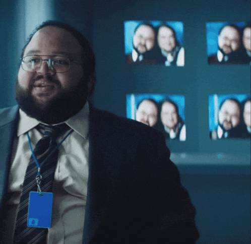 A Man In A Suit And Tie Is Standing In Front Of A Screen That Says " Nice Sack " GIF