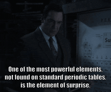 A Man In A Suit And Tie Is Standing In Front Of A Screen That Says " One Of The Most Powerful Elements " GIF