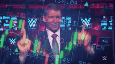 A Man In A Suit And Tie Is Standing In Front Of A Screen With A W Logo GIF