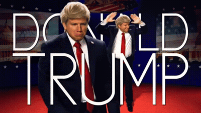 A Man In A Suit And Tie Is Standing In Front Of A Sign That Says Donald Trump GIF