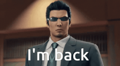 A Man In A Suit And Tie Is Standing In Front Of A Sign That Says I 'M Back GIF