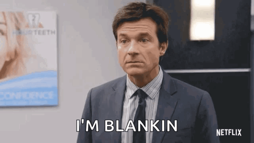 A Man In A Suit And Tie Is Standing In Front Of A Sign That Says I 'M Blankin GIF