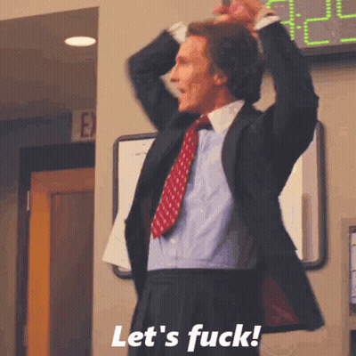 A Man In A Suit And Tie Is Standing In Front Of A Sign That Says Let 'S Fuck ! GIF