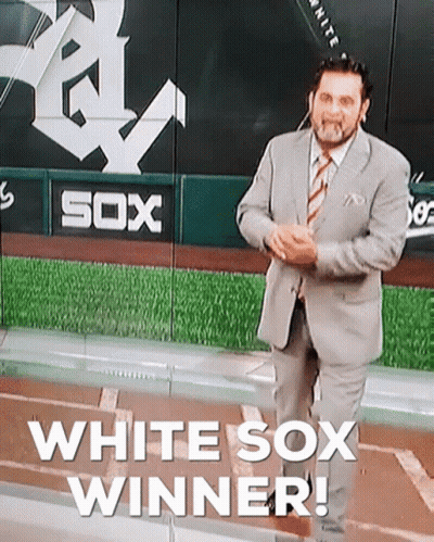 A Man In A Suit And Tie Is Standing In Front Of A Sign That Says Sox GIF