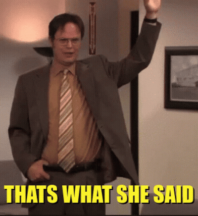 A Man In A Suit And Tie Is Standing In Front Of A Sign That Says " That 'S What She Said " GIF