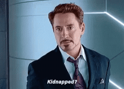 A Man In A Suit And Tie Is Standing In Front Of A Wall And Saying `` Kidnapped ? '' GIF