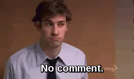 A Man In A Suit And Tie Is Standing In Front Of A Wall And Saying `` No Comment '' . GIF