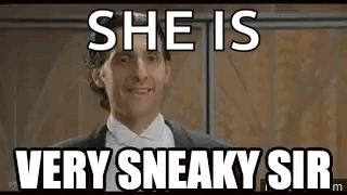 A Man In A Suit And Tie Is Standing In Front Of A Wall And Says `` She Is Very Sneaky Sir '' . GIF