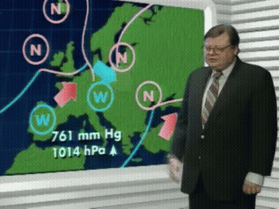 A Man In A Suit And Tie Is Standing In Front Of A Weather Map GIF