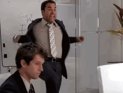 A Man In A Suit And Tie Is Standing In Front Of A White Board That Says G = C = T GIF