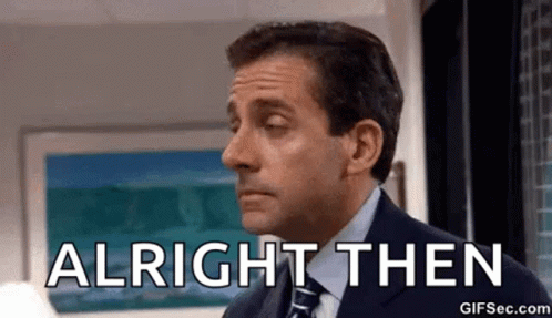 A Man In A Suit And Tie Is Standing In Front Of A Window And Saying `` Alright Then '' . GIF