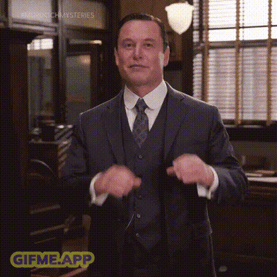 A Man In A Suit And Tie Is Standing In Front Of A Window In An Office . GIF
