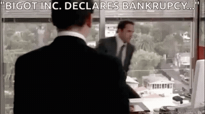 A Man In A Suit And Tie Is Standing In Front Of A Window In An Office . GIF
