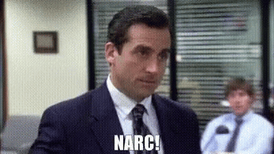 A Man In A Suit And Tie Is Standing In Front Of A Window In An Office . GIF