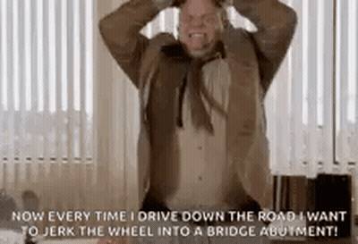 A Man In A Suit And Tie Is Standing In Front Of A Window With His Hands In His Hair . GIF