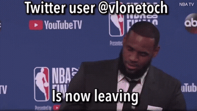 A Man In A Suit And Tie Is Standing In Front Of A Youtube Tv Banner GIF