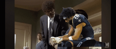A Man In A Suit And Tie Is Standing Next To A Man In A Blue Jersey With The Number 21 On It GIF