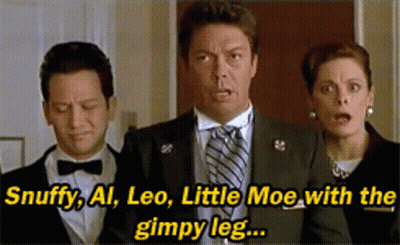 A Man In A Suit And Tie Is Standing Next To A Woman And A Man In A Bow Tie GIF