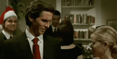 A Man In A Suit And Tie Is Standing Next To A Woman . GIF