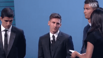 A Man In A Suit And Tie Is Standing Next To A Woman Holding A Microphone While Two Other Men Stand Behind Him . GIF