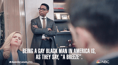 A Man In A Suit And Tie Is Standing Next To A Woman In A Blue Jacket With The Caption Being A Gay Black Man In America GIF