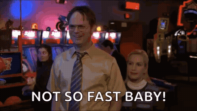 A Man In A Suit And Tie Is Standing Next To A Woman In An Arcade And Says `` Not So Fast Baby '' . GIF