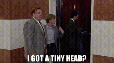 A Man In A Suit And Tie Is Standing Next To A Woman In An Elevator And Says I Got A Tiny Head ? GIF