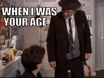 A Man In A Suit And Tie Is Standing Next To A Young Boy And Says When I Was Your Age GIF