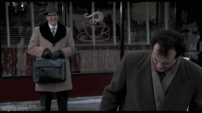 A Man In A Suit And Tie Is Standing Next To Another Man In A Suit And Tie . GIF