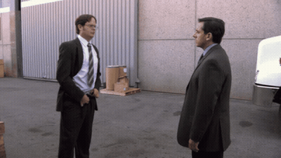 A Man In A Suit And Tie Is Standing Next To Another Man In A Suit GIF