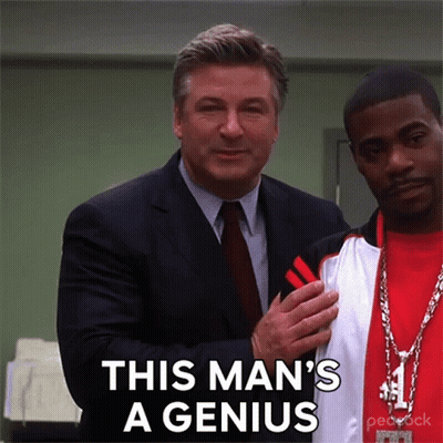 A Man In A Suit And Tie Is Standing Next To Another Man With The Words This Man 'S A Genius On The Bottom GIF