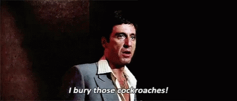 A Man In A Suit And Tie Is Standing On A Stage And Talking . GIF
