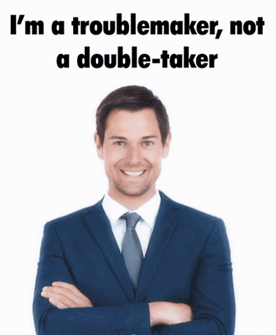 A Man In A Suit And Tie Is Standing With His Arms Crossed And Says I 'M A Troublemaker Not GIF