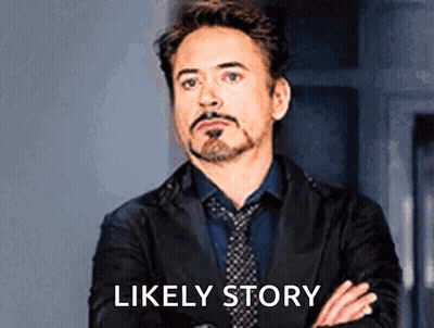 A Man In A Suit And Tie Is Standing With His Arms Crossed And The Words `` Likely Story '' Behind Him . GIF