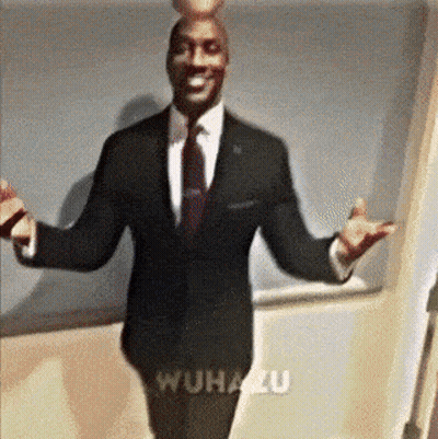 A Man In A Suit And Tie Is Standing With His Arms Outstretched In Front Of A Wall That Says Wuhanzu GIF