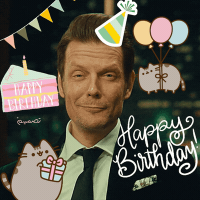 A Man In A Suit And Tie Is Surrounded By Balloons And A Birthday Cake GIF