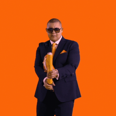 A Man In A Suit And Tie Is Surrounded By Confetti And A Bag That Says Haas GIF
