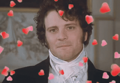 A Man In A Suit And Tie Is Surrounded By Red Hearts GIF