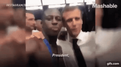 A Man In A Suit And Tie Is Taking A Selfie With A Man In A Suit And Tie . GIF