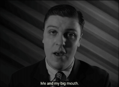 A Man In A Suit And Tie Is Talking About His Big Mouth GIF
