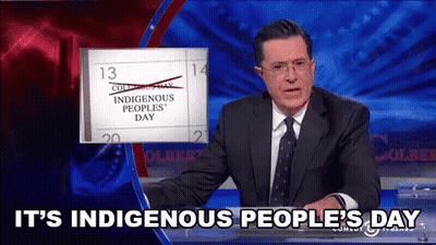 A Man In A Suit And Tie Is Talking About Indigenous Peoples ' Day GIF
