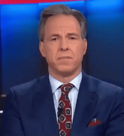 A Man In A Suit And Tie Is Talking About Something That Was A Hot Mess Inside A Dumpster GIF