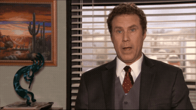 A Man In A Suit And Tie Is Talking In Front Of A Window GIF