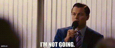 A Man In A Suit And Tie Is Talking Into A Microphone And Saying `` I 'M Not Going '' . GIF