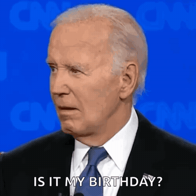 A Man In A Suit And Tie Is Talking Into A Microphone And Saying `` Is It My Birthday ? '' GIF