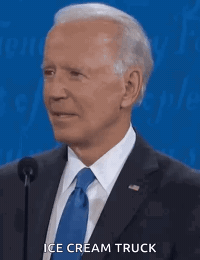 A Man In A Suit And Tie Is Talking Into A Microphone And Says " Ice Cream Truck " GIF