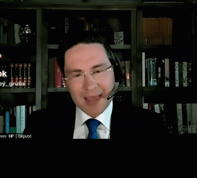 A Man In A Suit And Tie Is Talking Into A Microphone While Looking For A Dollar Figure GIF